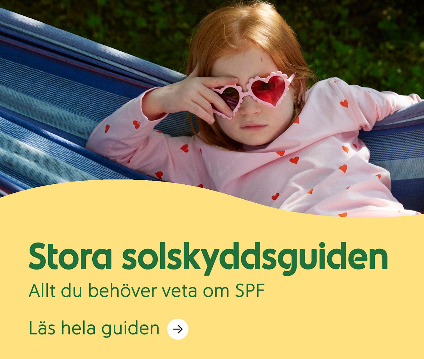 Rödhårig flicka ligger i en blå hängmatta utomhus och bär rosa solglasögon med hjärtformade glas. Text: Stora solskyddsguiden. Allt du behöver veta om SPF.