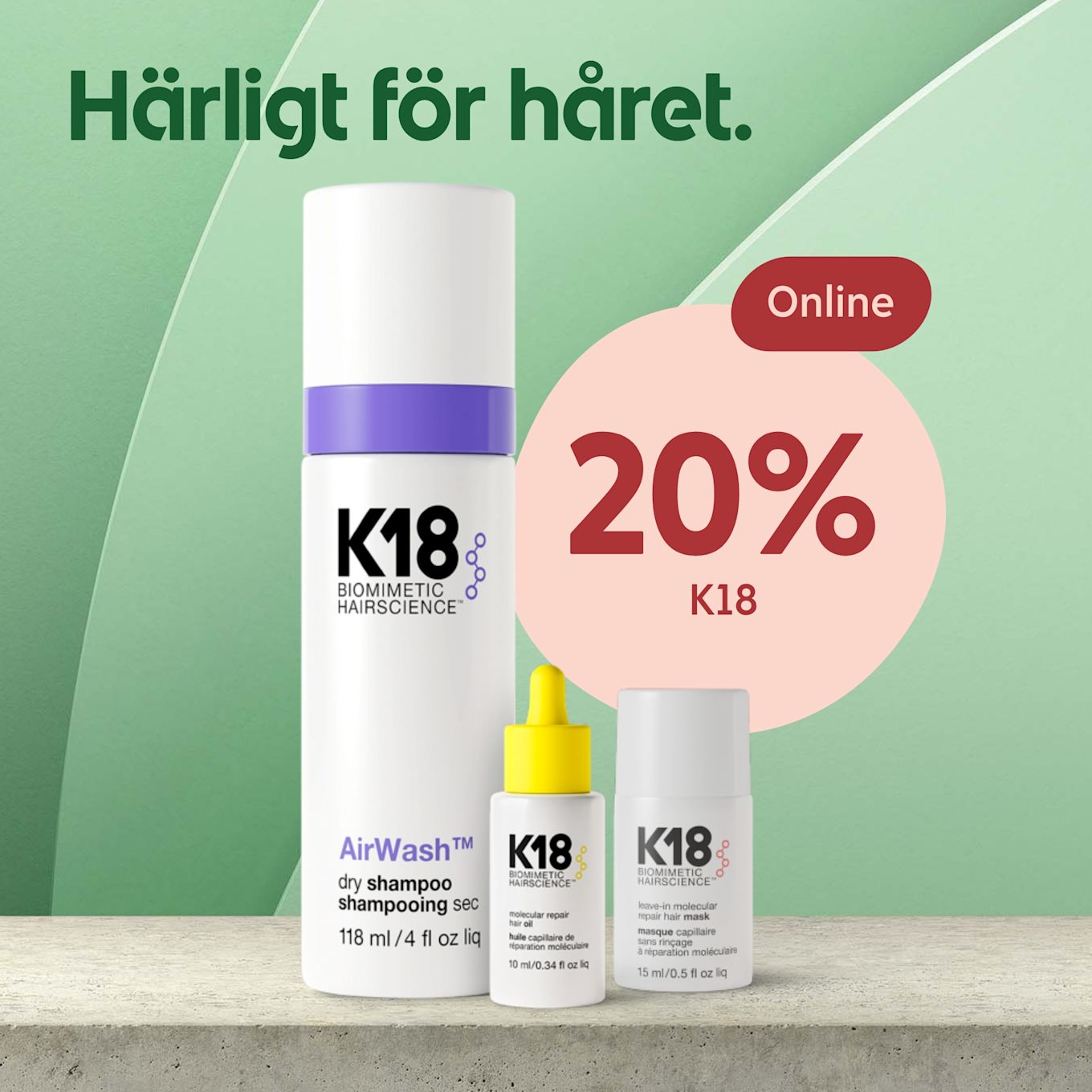 Tre K18 hårvårdsprodukter står på en betongyta med en grön bakgrund och texten "Härligt för håret" samt en rosa cirkel med texten "Online 20% K18".